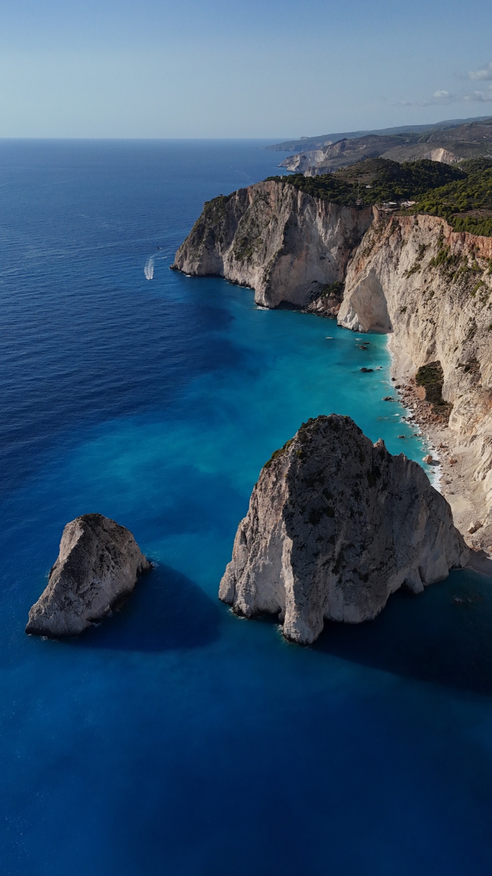 Rocky coastline above vivid blue water